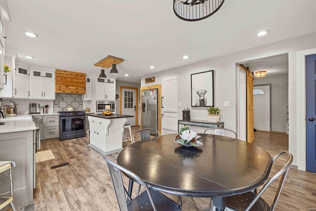 dining room with sink and light hardwood / wood-style floors