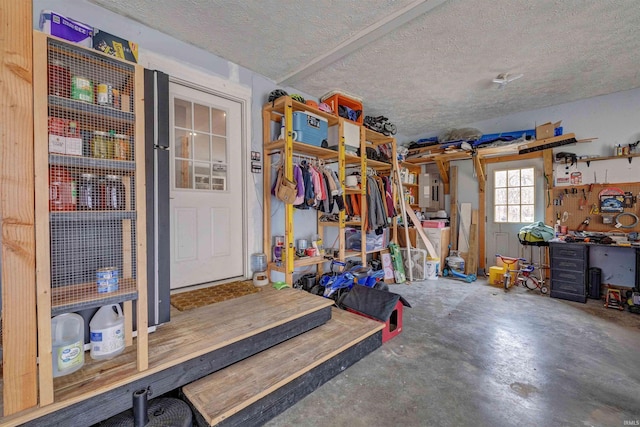 garage with a workshop area and electric panel