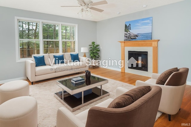 living room featuring hardwood / wood-style flooring, a fireplace, and ceiling fan