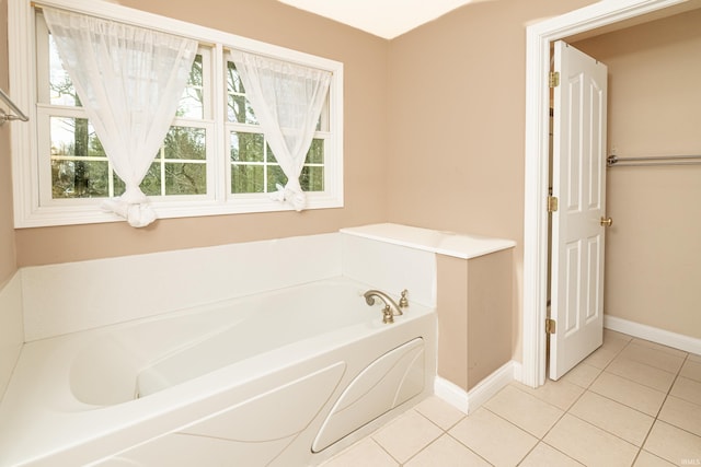 bathroom with tile patterned floors and a bathtub