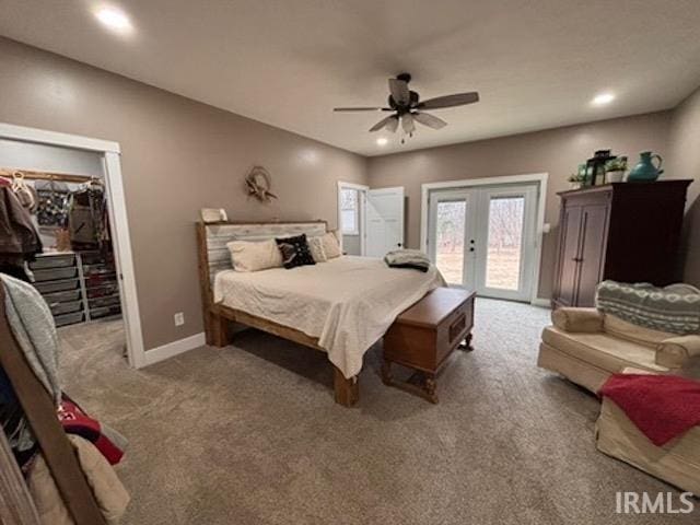 bedroom with ceiling fan, access to exterior, carpet flooring, a walk in closet, and french doors