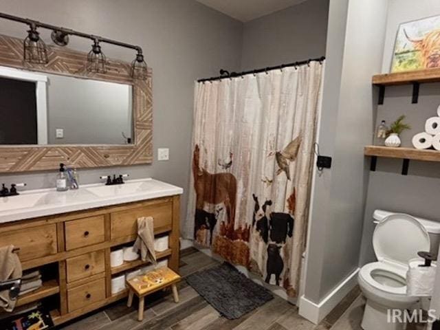 bathroom featuring vanity, toilet, curtained shower, and wood-type flooring