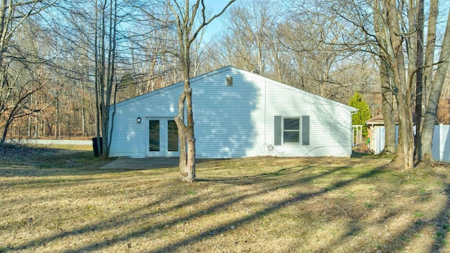 exterior space with a lawn and french doors