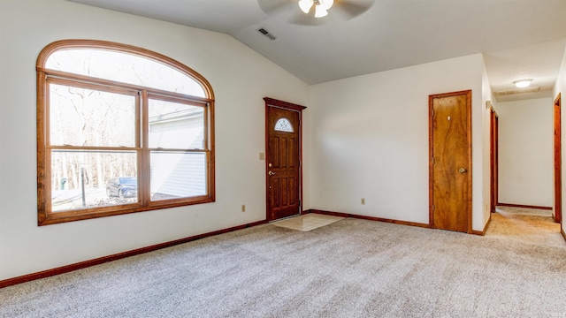 carpeted entrance foyer featuring vaulted ceiling and ceiling fan