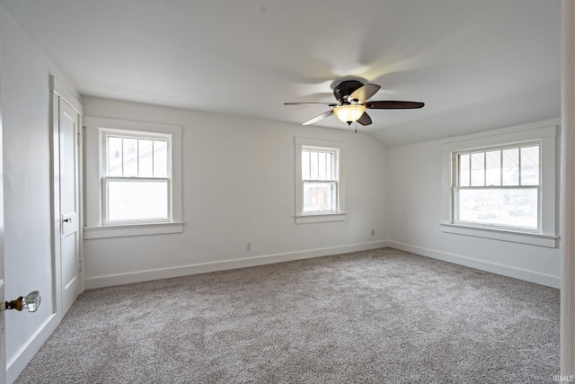 spare room featuring vaulted ceiling, carpet, and ceiling fan