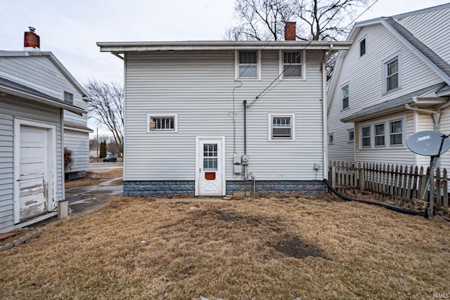 rear view of house with a yard