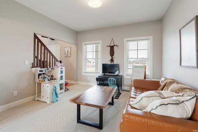 living room featuring plenty of natural light and light colored carpet