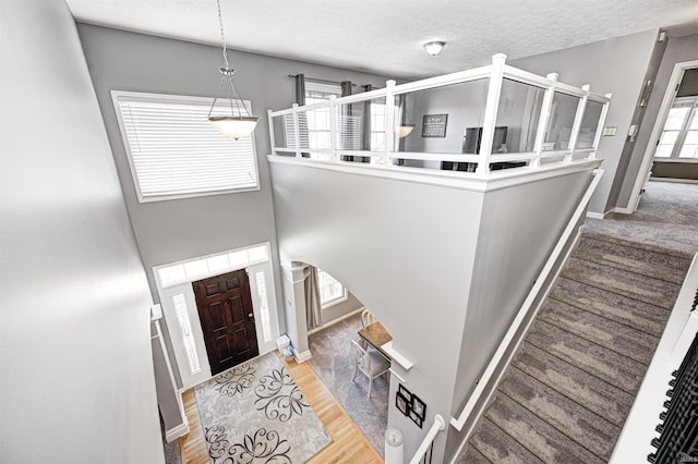 entrance foyer with wood-type flooring and a textured ceiling