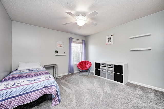 carpeted bedroom featuring a textured ceiling and ceiling fan