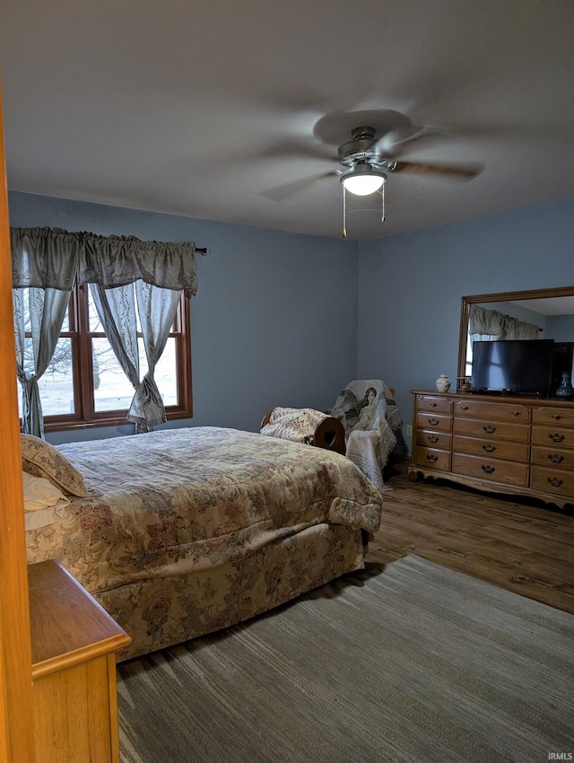 bedroom featuring ceiling fan and dark hardwood / wood-style floors