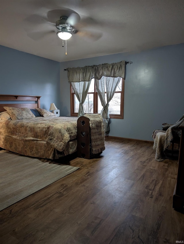unfurnished bedroom with dark wood-type flooring and ceiling fan