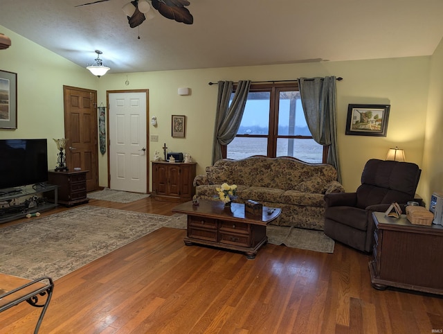 living room with wood-type flooring, a water view, and ceiling fan