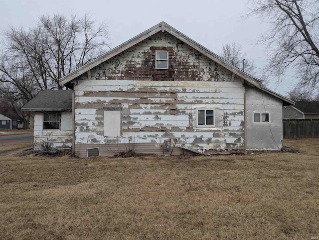 view of side of home featuring a lawn