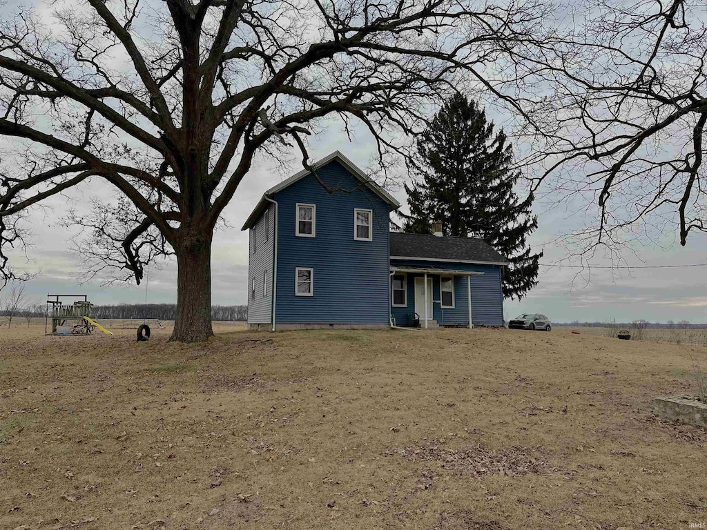 view of front of house featuring a rural view and a playground