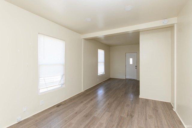 spare room with hardwood / wood-style flooring