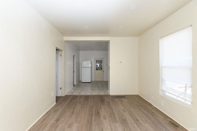 unfurnished room with light wood-type flooring