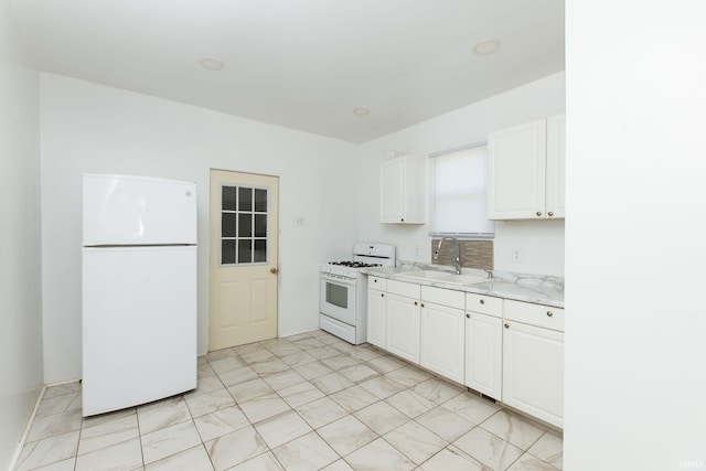 kitchen with white cabinetry, light stone countertops, sink, and white appliances