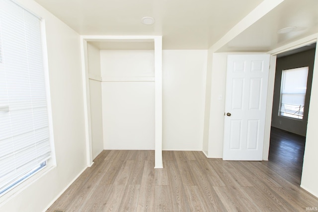 unfurnished bedroom featuring a closet and light hardwood / wood-style flooring