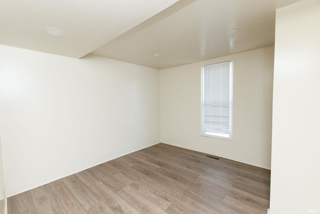 spare room featuring light wood-type flooring