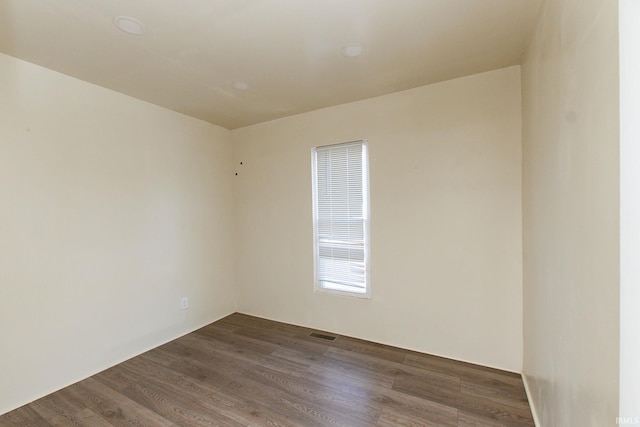 spare room with dark hardwood / wood-style floors