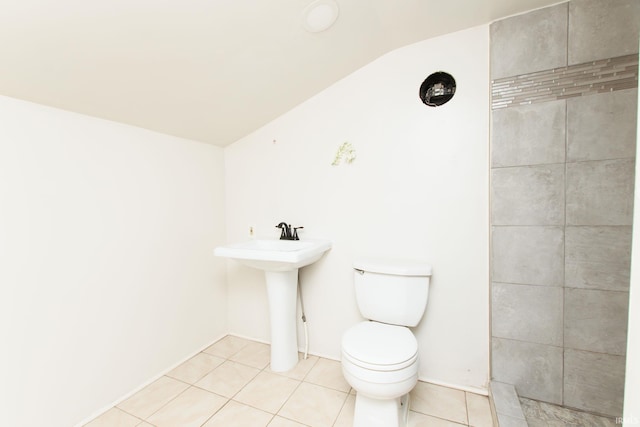 bathroom featuring lofted ceiling, tile patterned floors, and toilet