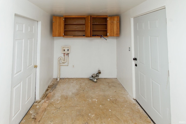 clothes washing area featuring cabinets