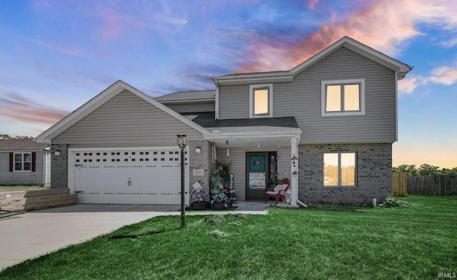 view of front of property with a garage and a yard