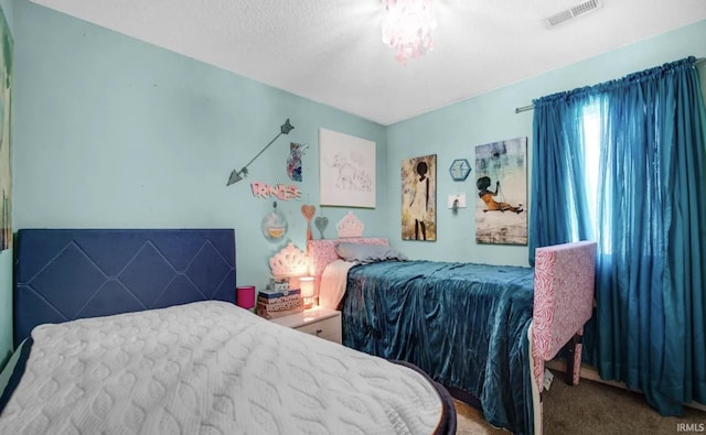 carpeted bedroom featuring a textured ceiling