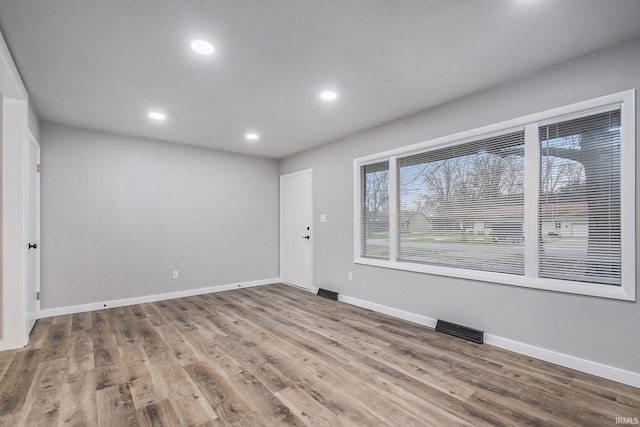 spare room with hardwood / wood-style flooring