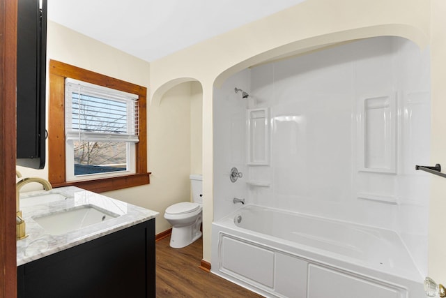 full bathroom featuring shower / bathing tub combination, vanity, wood-type flooring, and toilet