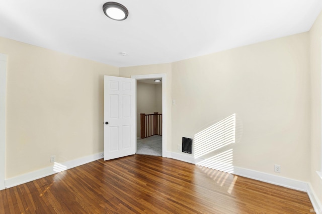 spare room featuring dark wood-type flooring