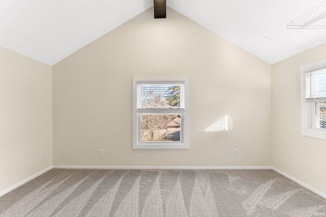 empty room with lofted ceiling with beams and carpet