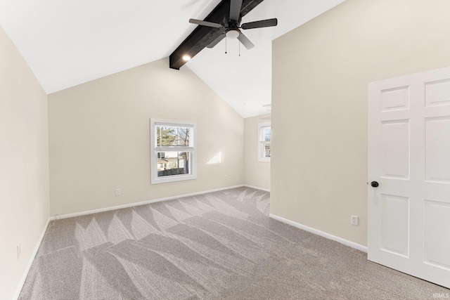 additional living space with lofted ceiling with beams, light colored carpet, and ceiling fan