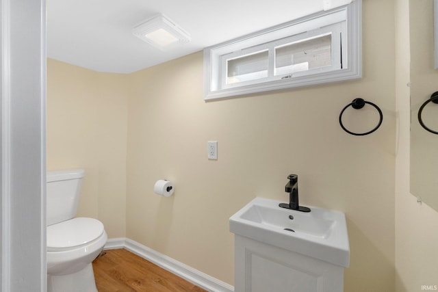 bathroom featuring sink, hardwood / wood-style flooring, and toilet