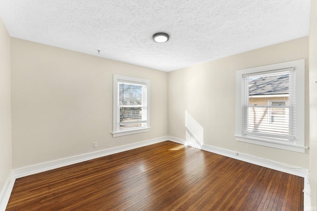 spare room with hardwood / wood-style floors and a textured ceiling