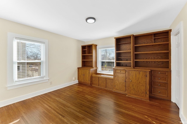 unfurnished living room with dark hardwood / wood-style flooring