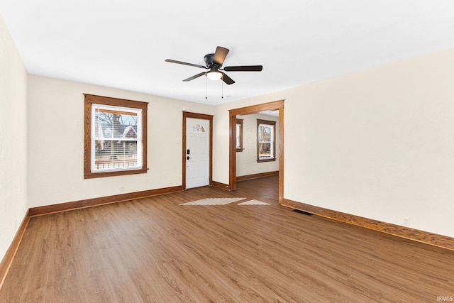 unfurnished room with ceiling fan and wood-type flooring