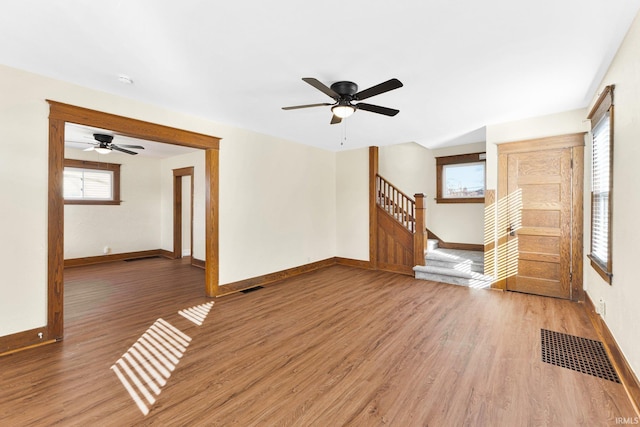 unfurnished living room featuring hardwood / wood-style flooring and ceiling fan