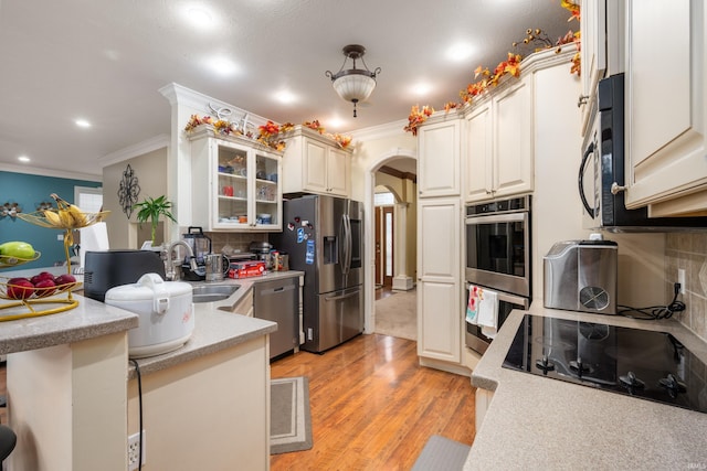 kitchen featuring white cabinetry, backsplash, sink, and black appliances