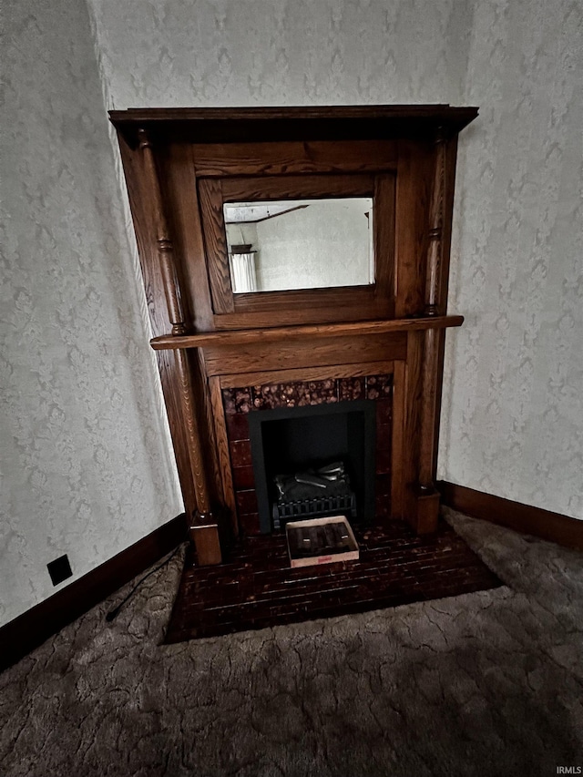 interior details featuring a tiled fireplace