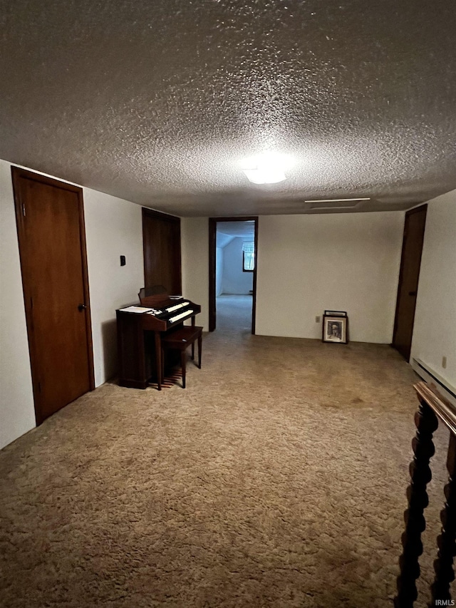 interior space featuring a textured ceiling and carpet flooring