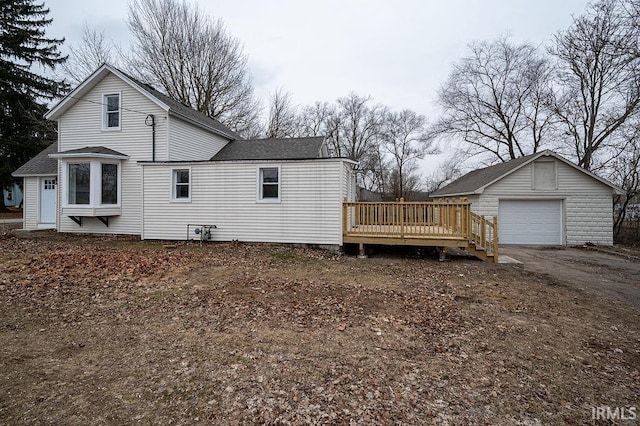 view of home's exterior featuring an outbuilding, a garage, and a deck