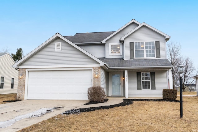 view of property featuring a garage and a front lawn