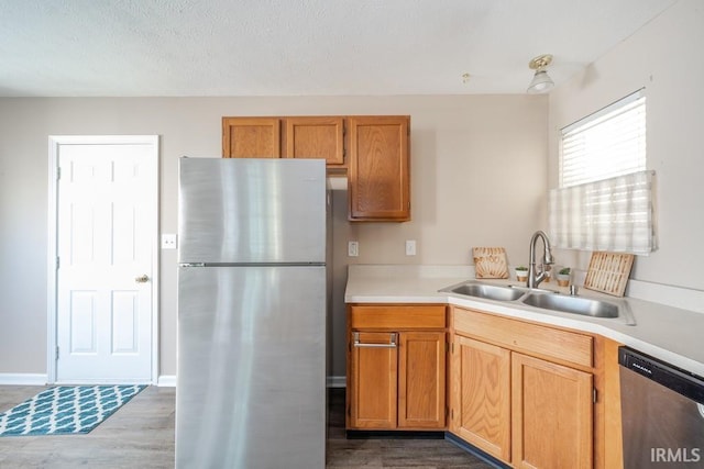 kitchen featuring dark hardwood / wood-style flooring, sink, and stainless steel appliances