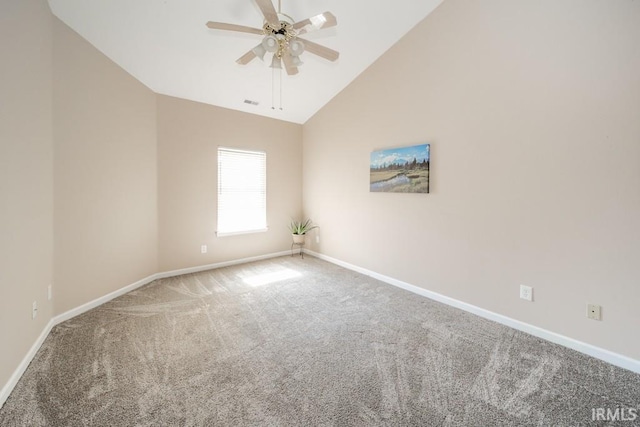 carpeted spare room with ceiling fan and high vaulted ceiling