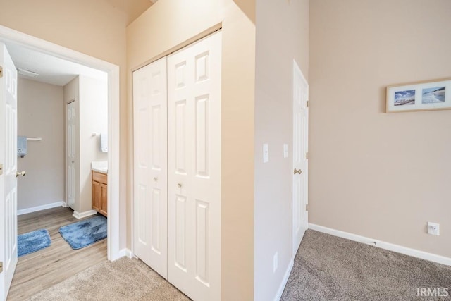 hall featuring light colored carpet