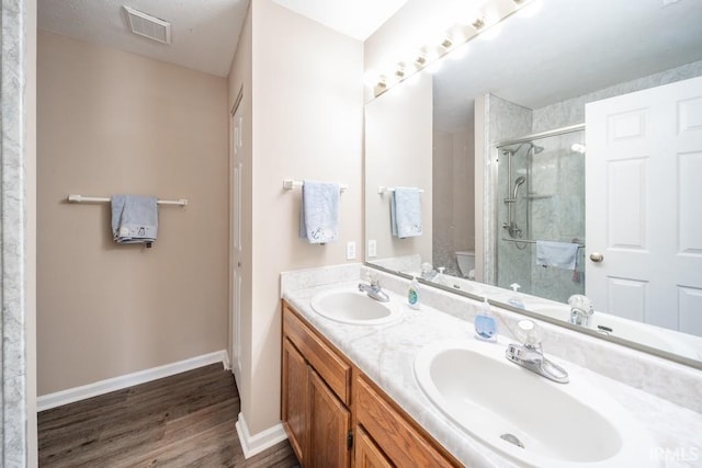 bathroom with vanity, hardwood / wood-style floors, toilet, and walk in shower