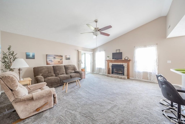 carpeted living room featuring a brick fireplace, high vaulted ceiling, and ceiling fan