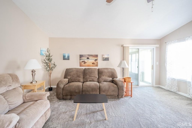 carpeted living room featuring vaulted ceiling