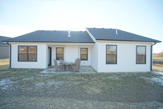 rear view of house featuring a yard and a patio area